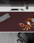 Chibi Megumin anime desk pad, 40x20 inches, featuring her bold reds and fire-tipped hat on a deep brown backdrop.