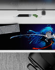 Midnight-to-neon blue anime desk pad 36x16 inches with orange ribbon accents for a sleek late-night vibe.