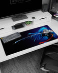 Blue-haired sword heroine in motion on anime girl desk pad 36x16 inches, blade line and wind-swept hair.
