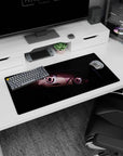 Close-up anime girl peeking from shadows with candy pink eyes on a 32x16 inches extended desk mat.
