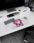 Flustered pink-haired anime girl in chunky navy headphones on a 28x12 inches mouse pad, like she paused music.