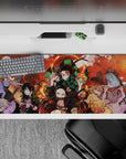 36x16 inches desk pad showcasing Tanjiro, Nezuko, and the Demon Slayer Corps in an intense battle with vibrant colors and fierce energy.
