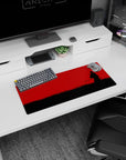 28x12 inches anime desk mat showing cloaked swordsman with scarf in wind, blade low in black grass.