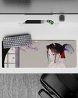 32x12 inches desk mat in soft spring tones—warm gray, lilac petals, calm cozy anime aesthetic.