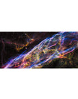 Cosmic ribbon galaxy desk pad 36x16 inches with swirling neon trails and star-speckled space backdrop.