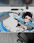 40x20 inches desk pad showcasing Tanjiro’s Water Breathing technique, with dynamic blue strokes and intense precision, perfect for Demon Slayer fans.