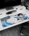 Artistic 36x16 inches desk pad showcasing Tanjiro Kamado’s Water Breathing technique, perfect for fans of dynamic, powerful anime designs.