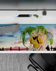 Cute anime desk pad 36x16 inches in lime green hair and warm pink-gold blush tones, feel-good vibe.