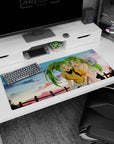 Two ponytailed green-haired anime girls giggling at sunset on a 36x16 inches desk pad by a fence.