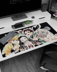 Premium 40x20 inch desk pad with bold design of Tanjiro and friends, perfect for anime enthusiasts