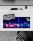 Compact 28x12 desk mat highlights neon lights and water reflections for immersive urban vibes