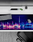 Striking 36x16 desk pad highlights neon skyline reflections with intricate details and vibrant night hues