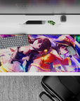 Anime desk pad 36x16 inches featuring Megumin and Komekko from KonoSuba, showcasing vibrant purples and magical energy.