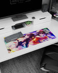 Anime mouse pad 32x12 inches featuring Megumin and Komekko from KonoSuba, vibrant purples, pinks, and golden flares.