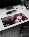 Anime girl mouse pad 32x16 inches showing black-haired girl grinning, teasing a card by her lips.