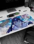 40x20 inches desk pad featuring a cute anime girl leaning in to cheer you on, with floating light swirls.