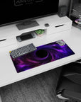 Spiraling violet clouds into a dark center with scattered stars on a mouse pad, 28x12 inches.