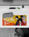 28x12 inches anime mouse pad in bold orange heat with red, indigo, and pink accents, street-poster vibe.
