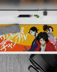36x16 inches anime desk pad in bold orange heat with red, indigo, and pink street-poster energy.