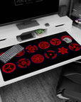 40x20 inches Naruto desk pad showing Sasuke Uchiha Sharingan eyes staring from a dark, hypnotic design.