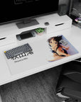 Akiyama Mio seated in a glossy black bikini, over-the-shoulder shy glance anime mouse pad, 32x16 inches.