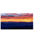 Mouse pad featuring a sunset with fiery skies and serene mountains, 32x16 inches, for a calming, breathtaking workspace vibe.