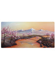 Mouse pad featuring cherry blossom landscape, 32x16 inches, with snow-capped mountains and delicate blossoms, evoking peace and tranquility.