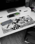Workspace-ready 36x16 inch desk pad with Tanjiro and Nezuko's dynamic action, ideal for manga lovers