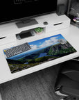 Modern 32x16 inches mouse pad featuring a cliffside view with a blue river, green valleys, and soft clouds for a serene look.