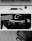 Minimal monochrome anime desk mat with crimson Sharingan pop, intense vibe, 32x16 inches.
