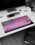 Modern 32x16 inches mouse pad featuring Blossom Horizon, showcasing a cherry blossom tree and tranquil pink sunset with distant mountains.