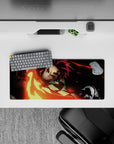 Anime mouse pad 28x12 inches featuring Tanjiro's fiery sword swing from Demon Slayer, in vivid reds and golds.