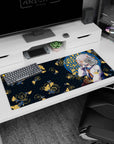 Silver-haired amber-eyed anime girl desk pad 36x16 inches, framed by blue window with golden koi shower.