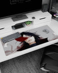 Calm black-haired anime character staring ahead on a 36x16 inches desk pad, red ribbon mark and haze behind.
