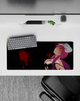 28x12 inches purple and black mouse pad with neon-red eyes and crimson splatter, edgy wicked vibe.