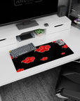 Naruto Akatsuki Itachi-inspired anime mouse pad 28x12 inches with red clouds on black.