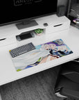 Silver-haired anime duo mouse pad 28x12 inches, one in a big violet witch hat cuddling under a cloak.