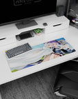 Two silver-haired anime girls cuddling under a white cloak, one in a violet witch hat, mouse pad 32x12 inches.