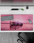 Dynamic 32x16 desk mat combines sleek car design with soft pink hues for impactful and stylish visuals