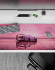 Striking 36x16 desk pad highlights serene landscape and sleek car with vibrant pink and sun details
