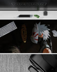 Dark charcoal shadow anime desk pad 40x20 inches with bright orange spiral mask and crisp white-red accents.