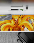 Hot orange and gold chakra flames with bold black line art, cozy high-energy anime desk pad, 36x16 inches.