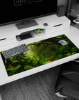 Tranquil 36x16 anime desk mat with moss-covered trees, ferns, vines, and mist for a serene, nature-filled workspace experience