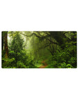 Rainforest 32x16 mouse pad with moss-covered trees, ferns, and vines, with soft light filtering through mist for a calming rainforest vibe