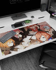 40x20 inches anime girl desk pad scene: winking girl shushes, glasses girl complains, green bow troublemaker.