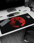 Silhouette sword wielder beneath a huge red moon with birds crossing the sky, anime desk pad 40x20 inches.