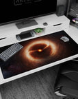 Tiny burning star desk pad 40x20 inches surrounded by curling amber clouds and faint space lights.