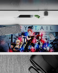 Neon red and electric blue Fairy Tail anime desk pad 36x16 inches with bold, gritty friendship vibe.