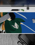 Anime desk pad 40x20 inches featuring a Scout Regiment soldier from Attack on Titan, mid-air with blades drawn.
