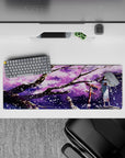 32x12 inches anime desk mouse pad in dreamy purple tones with lilac clouds, ink-black branches, and white flakes.